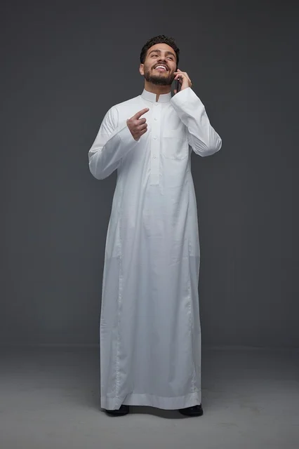 Saudi Man in Thobe Talking on Smartphone