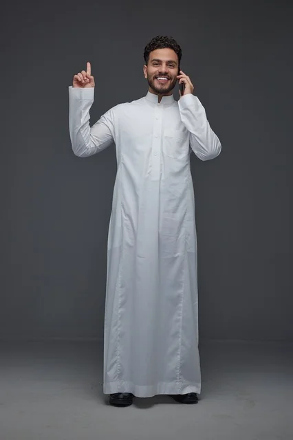 Saudi Man in Thobe Talking on Smartphone Studio