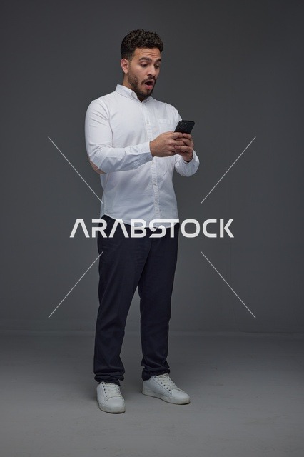 Surprised Saudi Man Using Smartphone in Studio