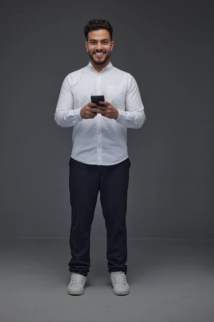Saudi Man Using Smartphone in Studio Portrait