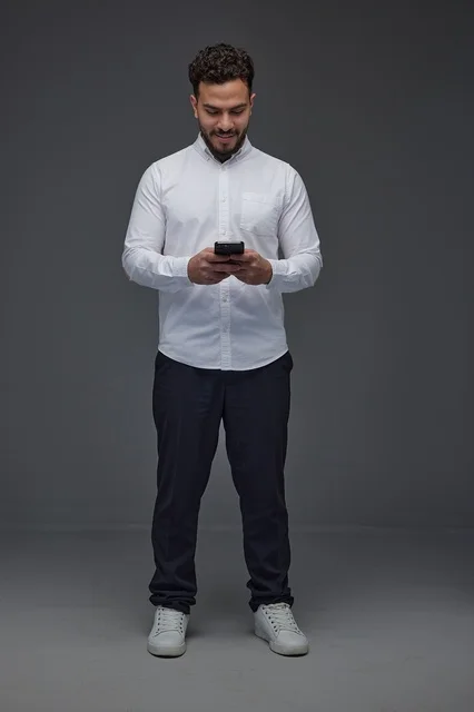 Saudi Man Using Smartphone in Studio Setting