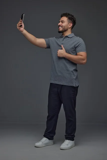 Saudi Man Taking Selfie with Thumbs Up in Studio
