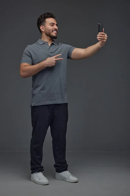Saudi Man Taking Selfie with Smartphone in Studio