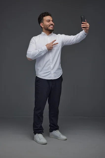 Saudi Man Taking Selfie with Smartphone in Studio