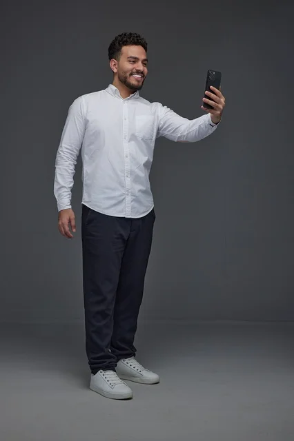 Saudi Man Taking Selfie with Smartphone in Studio