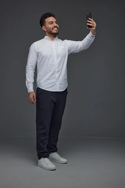 Saudi Man Taking Selfie with Smartphone in Studio