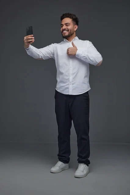Saudi Man Taking Selfie with Smartphone Thumbs Up