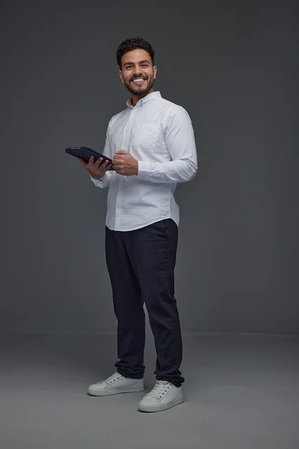 Man Holding Digital Tablet on Grey Studio Background