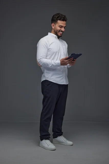 Smiling Saudi Man Using Digital Tablet Studio Portrait