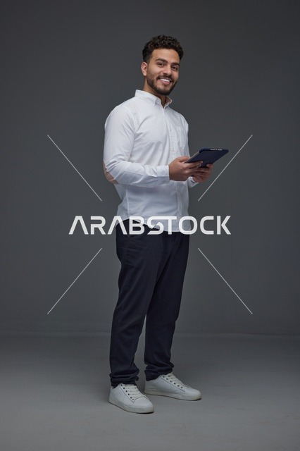 Saudi Man Using Digital Tablet in Studio