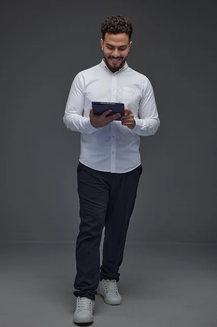 Saudi Man Using Tablet in Grey Studio