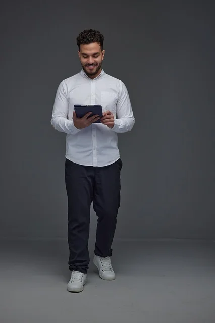 Saudi Man Using Digital Tablet in Studio Full Body