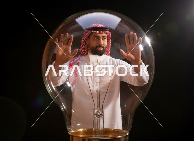 رجل سعودي مع مصباح كهربائي لمفهوم الابتكار