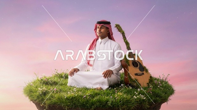 رجل سعودي يتأمل على جزيرة طائرة مع جيتار