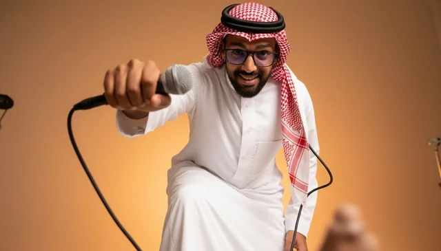 Saudi Man in Traditional Thobe Holding Microphone in Studio
