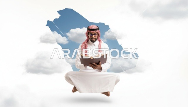 رجل سعودي يقرأ كتاباً أمام خريطة المملكة