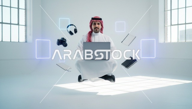 رجل سعودي يطفو مع جهاز محمول في استوديو أبيض