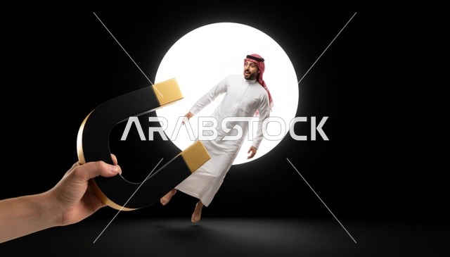 رجل سعودي ينجذب لمغناطيس كبير مفهوم تجاري