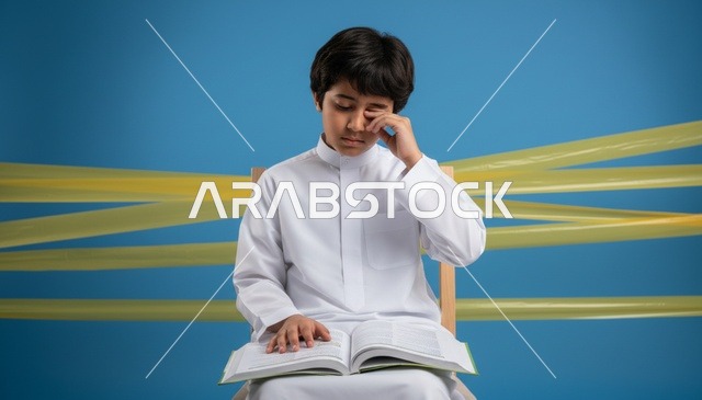 Tired Saudi Boy Studying with Book