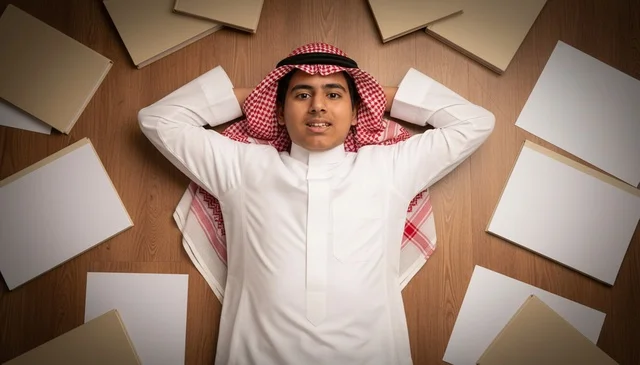 Saudi Student in Traditional Dress Lying on Floor