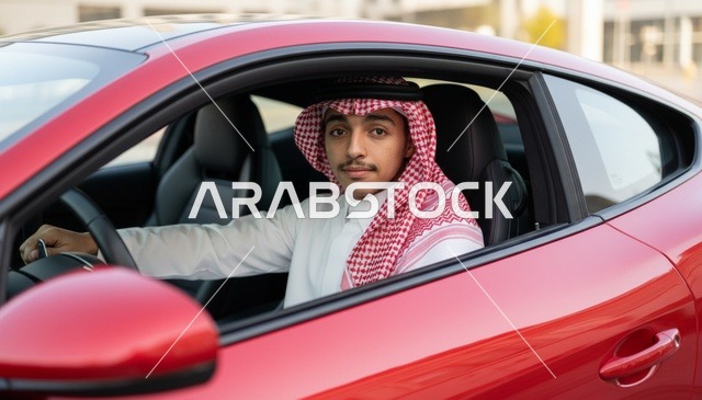 شاب سعودي داخل سيارة رياضية حمراء فاخرة