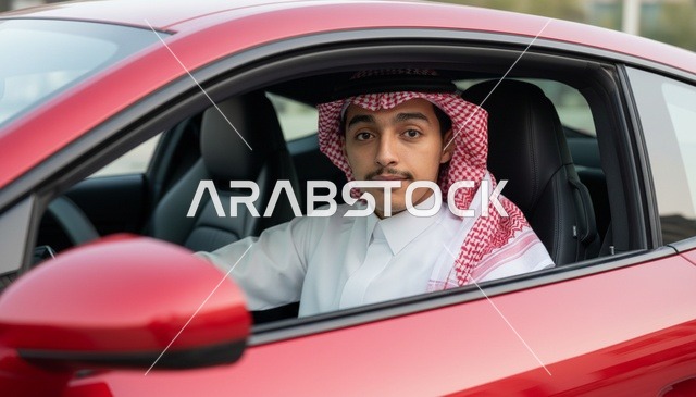 شاب سعودي بالزي التقليدي يقود سيارة حمراء