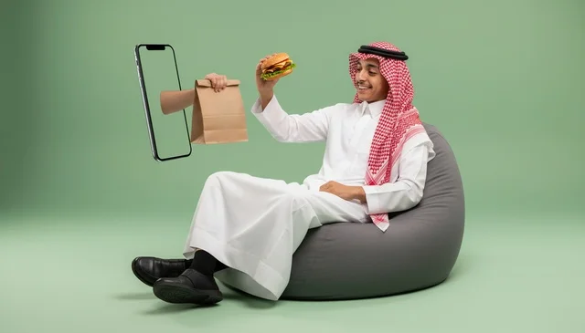 Saudi Man Using Smartphone App for Food Delivery