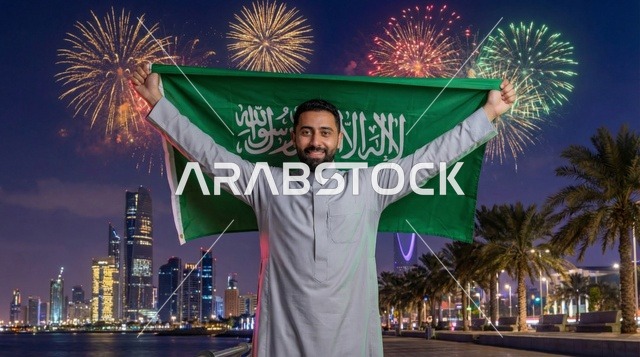 رجل سعودي يحمل العلم مع ألعاب نارية في الرياض