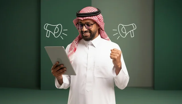 Saudi Man with Tablet Celebrating News on Green Background