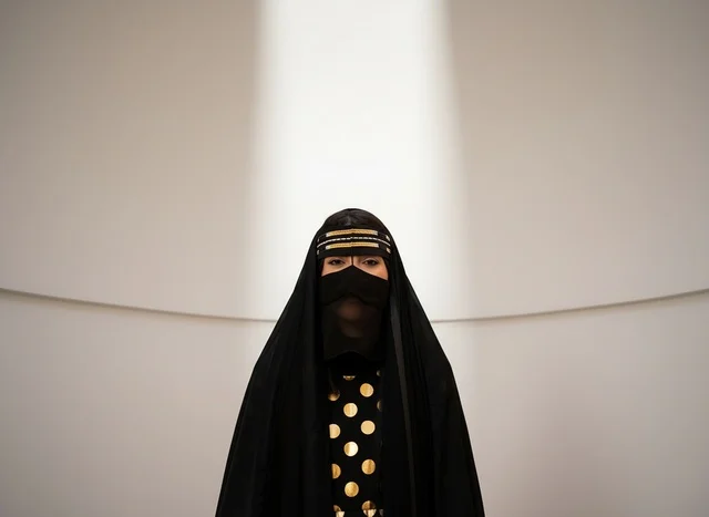 Emirati Woman in Traditional Niqab and Gold Patterned Abaya