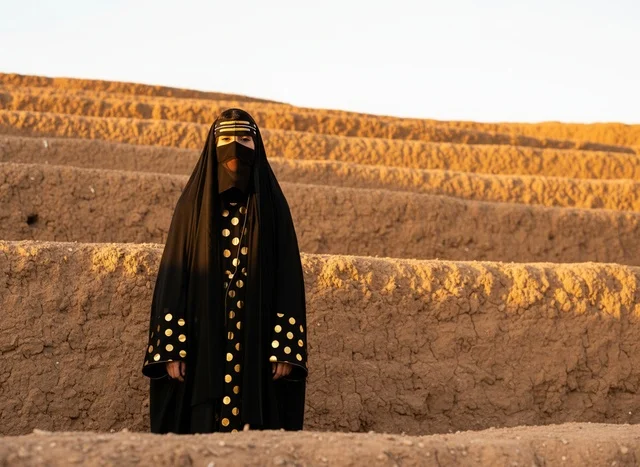 Saudi Woman in Traditional Heritage Dress in Desert