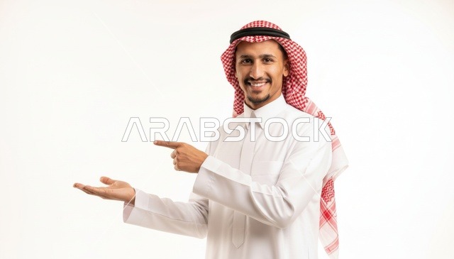 Saudi Man Pointing to Empty Space on White Background
