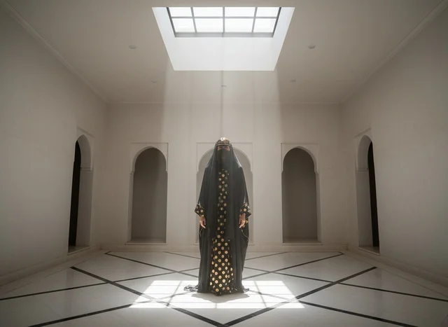 Emirati Woman in Traditional Abaya Under Skylight