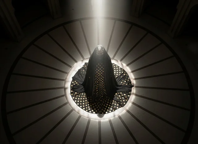 Saudi Woman in Black Abaya Under Light Beam