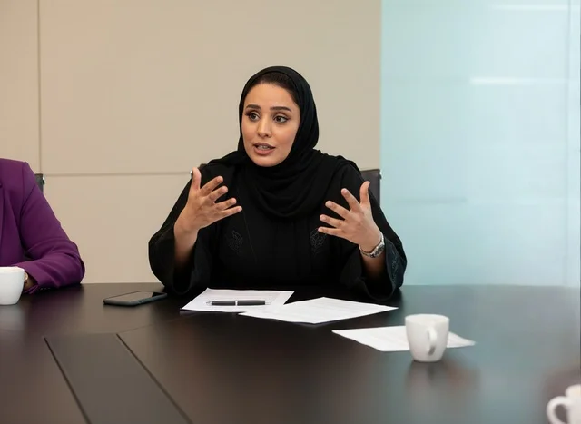 Emirati Businesswoman in Abaya Speaking at Office Meeting