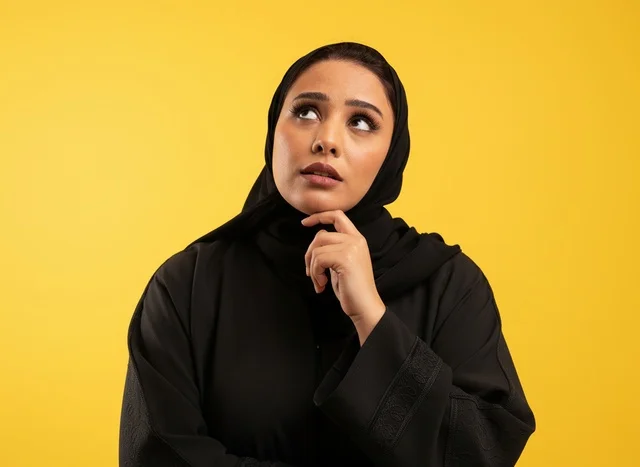 Thinking Saudi Woman in Black Abaya on Yellow Background