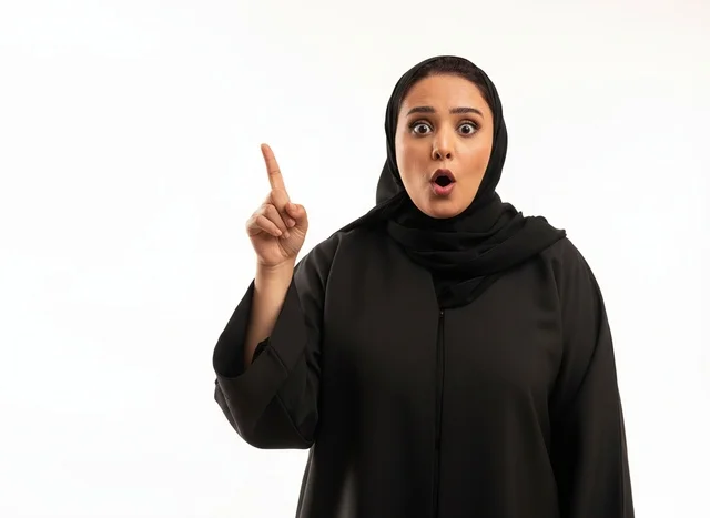 Surprised Saudi Woman in Abaya Pointing Up White Background