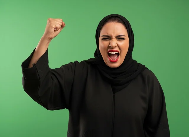 Arab Woman in Abaya Shouting with Raised Fist Green Screen