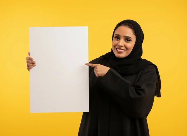 Saudi Woman in Abaya Pointing at Blank Board on Yellow
