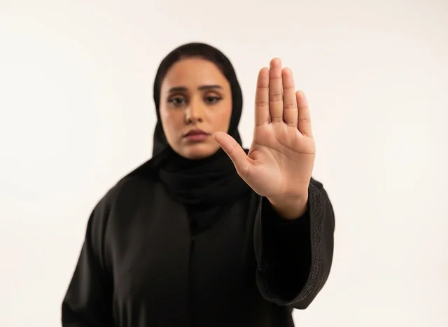 Saudi Woman in Abaya Making Stop Hand Gesture