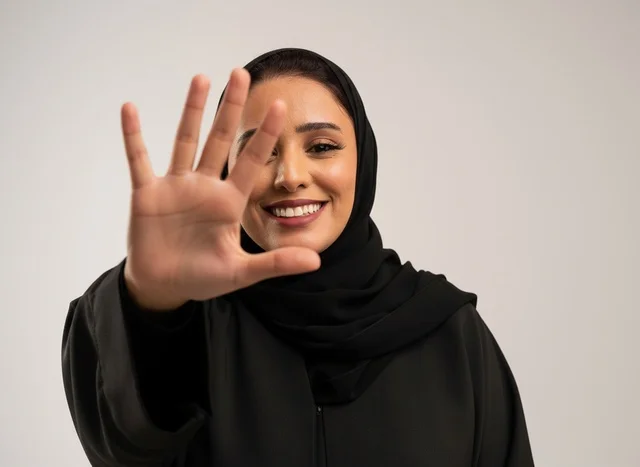 Saudi Woman in Abaya Holding Up Five Fingers