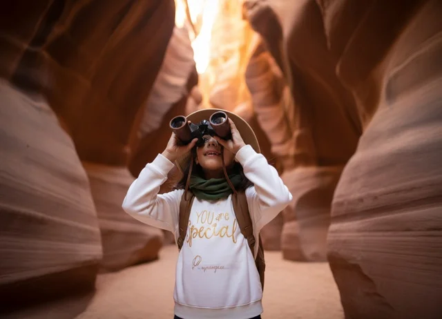Arab Girl Exploring Sandstone Canyon with Binoculars
