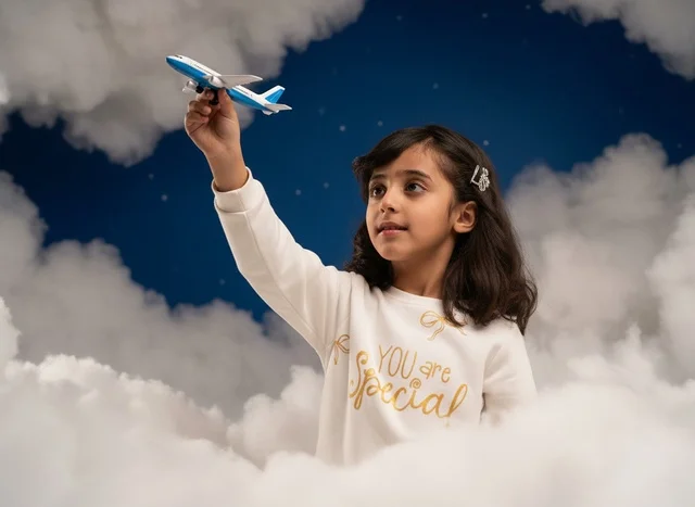 Saudi Girl Holding Toy Airplane with Dream Clouds