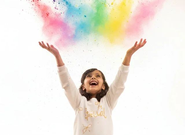Happy Saudi Girl Throwing Colorful Powder in Studio