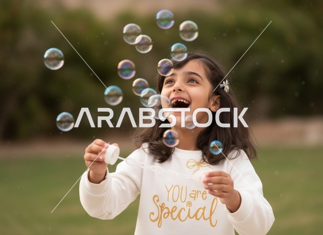 Arab Girl Playing with Bubbles in Outdoor Park