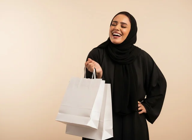 Saudi Woman in Abaya Holding Shopping Bags in Studio