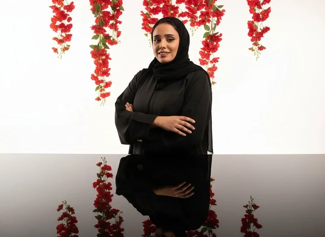 امرأة سعودية بالعباءة السوداء مع انعكاس في الاستوديو