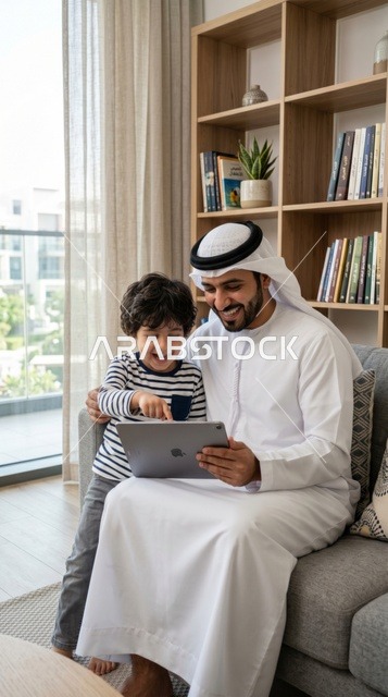 Saudi Father and Son Using Tablet for Home Education