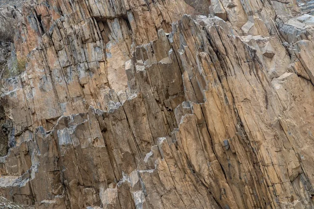 Vertical Rock Formations and Geological Mountain Texture