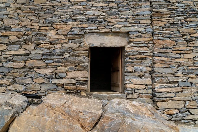Traditional Stone Wall with Wooden Door Entrance